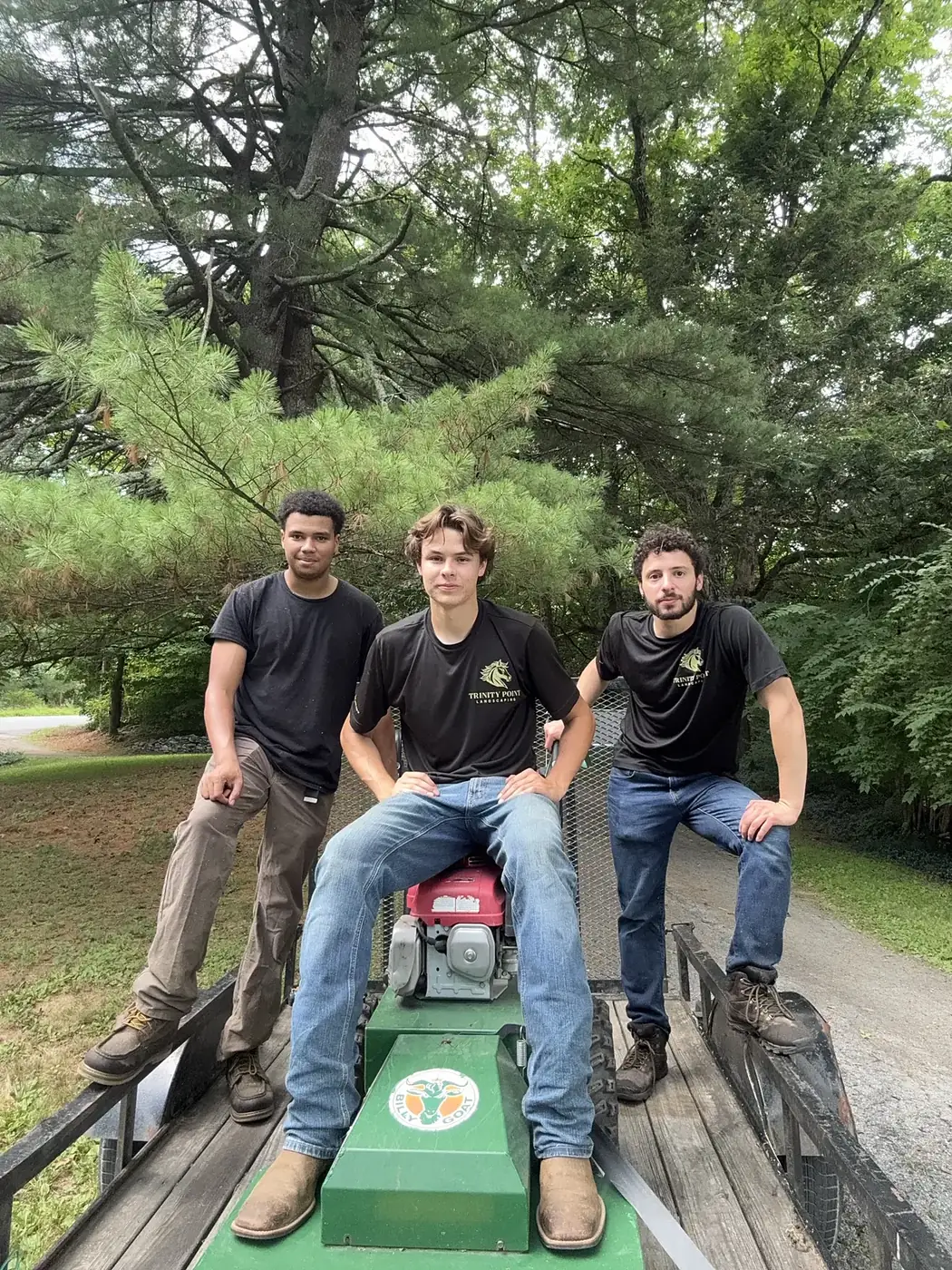 The Trinity Point Landscaping crew on the trailer with a brush mower
